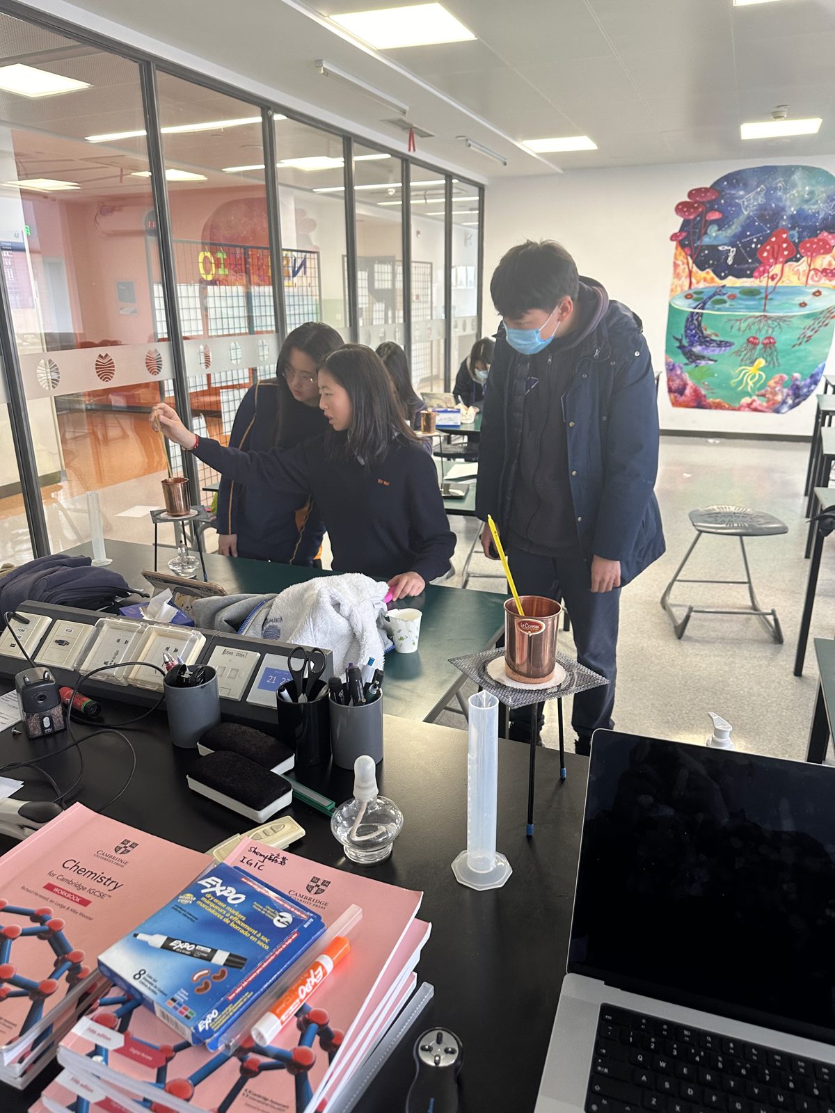 QTS portfolio and reference materials on a classroom shelf