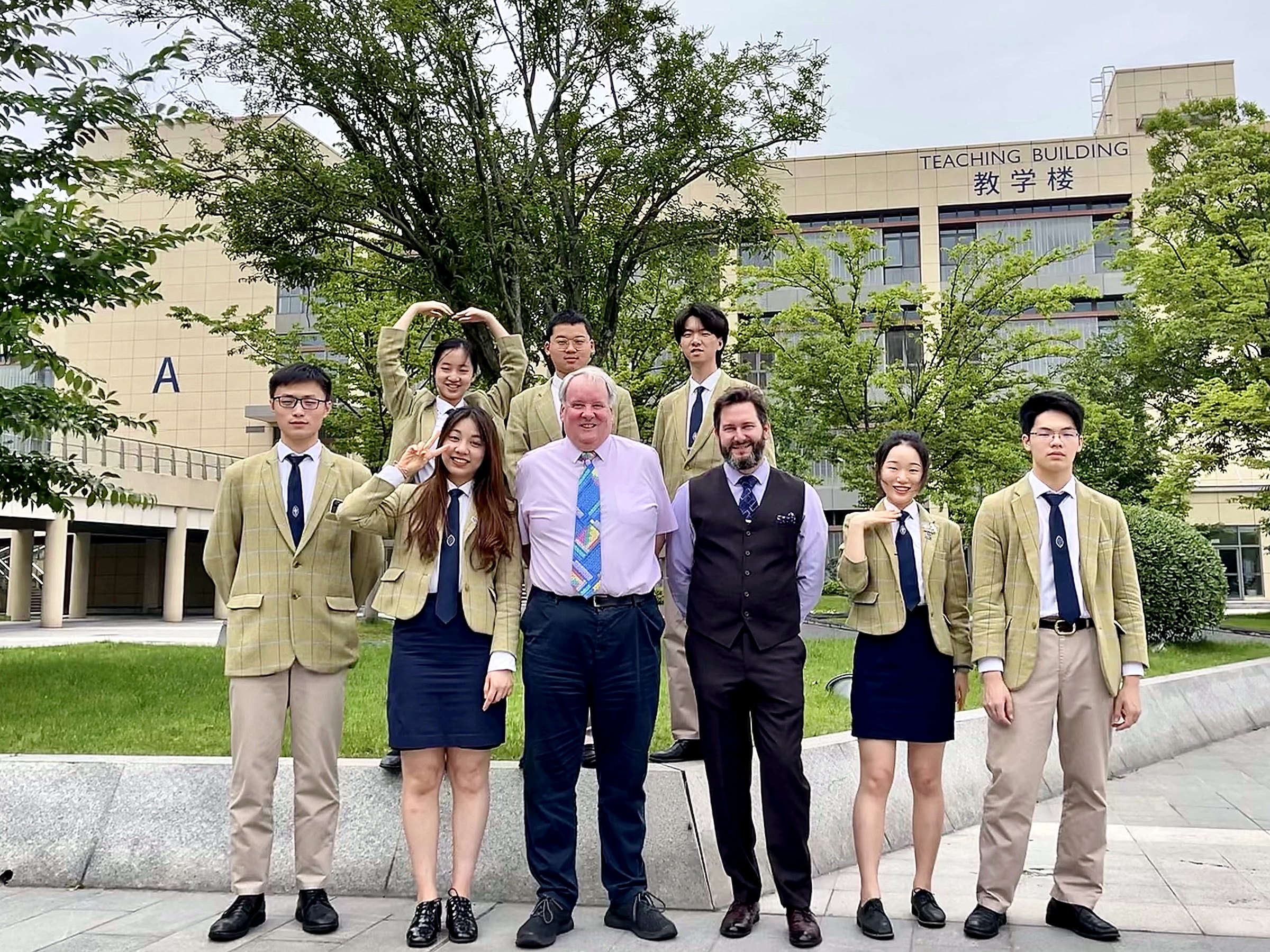 Andrew Greaves and Deputy Principal Daniel with Chemistry students outside the Teaching Building