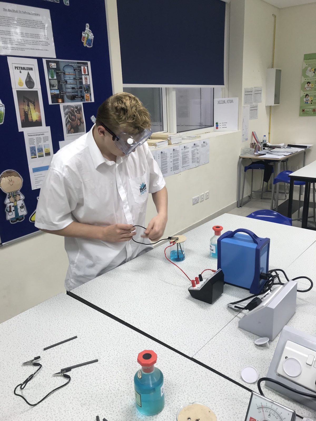 Student setting up an experiment under teacher supervision