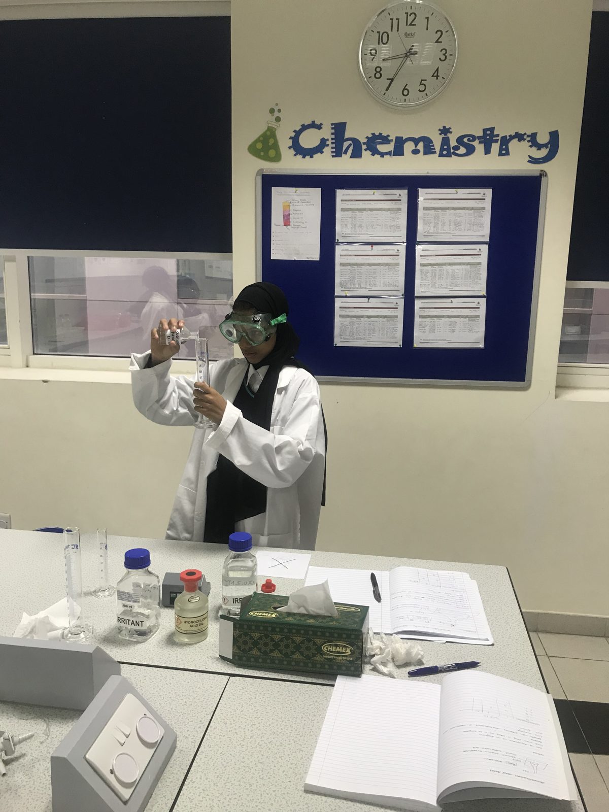 Close-up of a chemistry student working with laboratory glassware